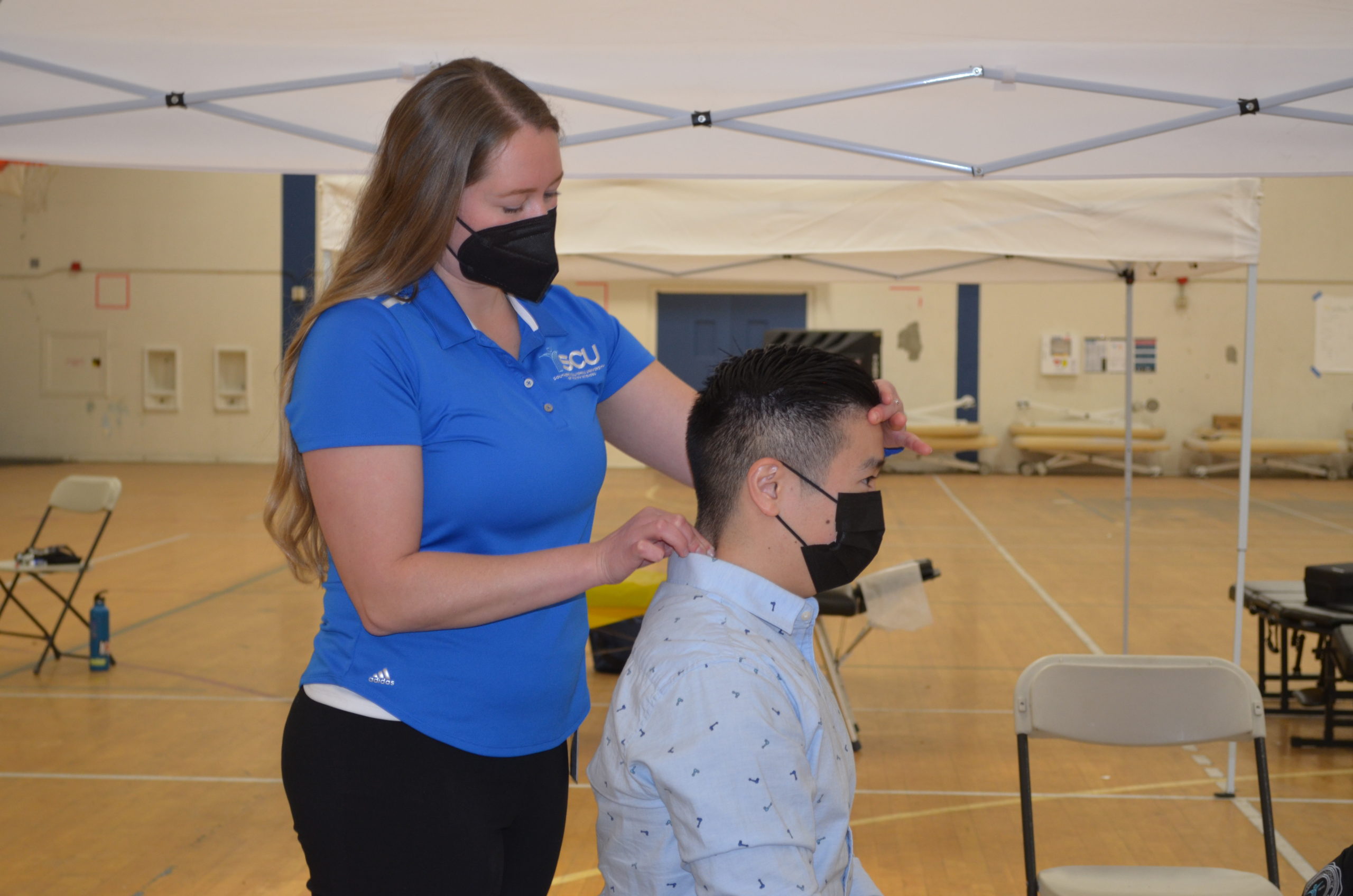 A photo of a patient receiving treatment at the SCU Health Tent Event