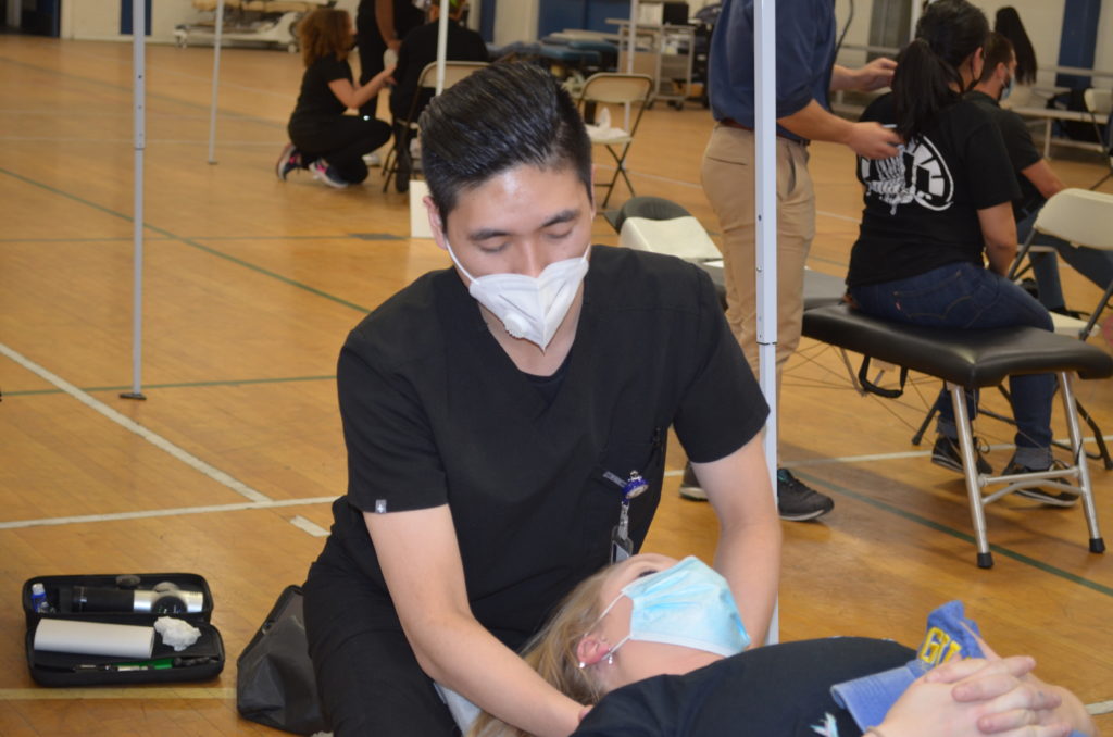 A photo of a patient receiving treatment at the SCU Health Tent Event