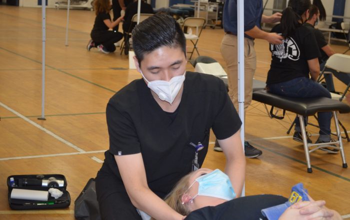A photo of a patient receiving treatment at the SCU Health Tent Event