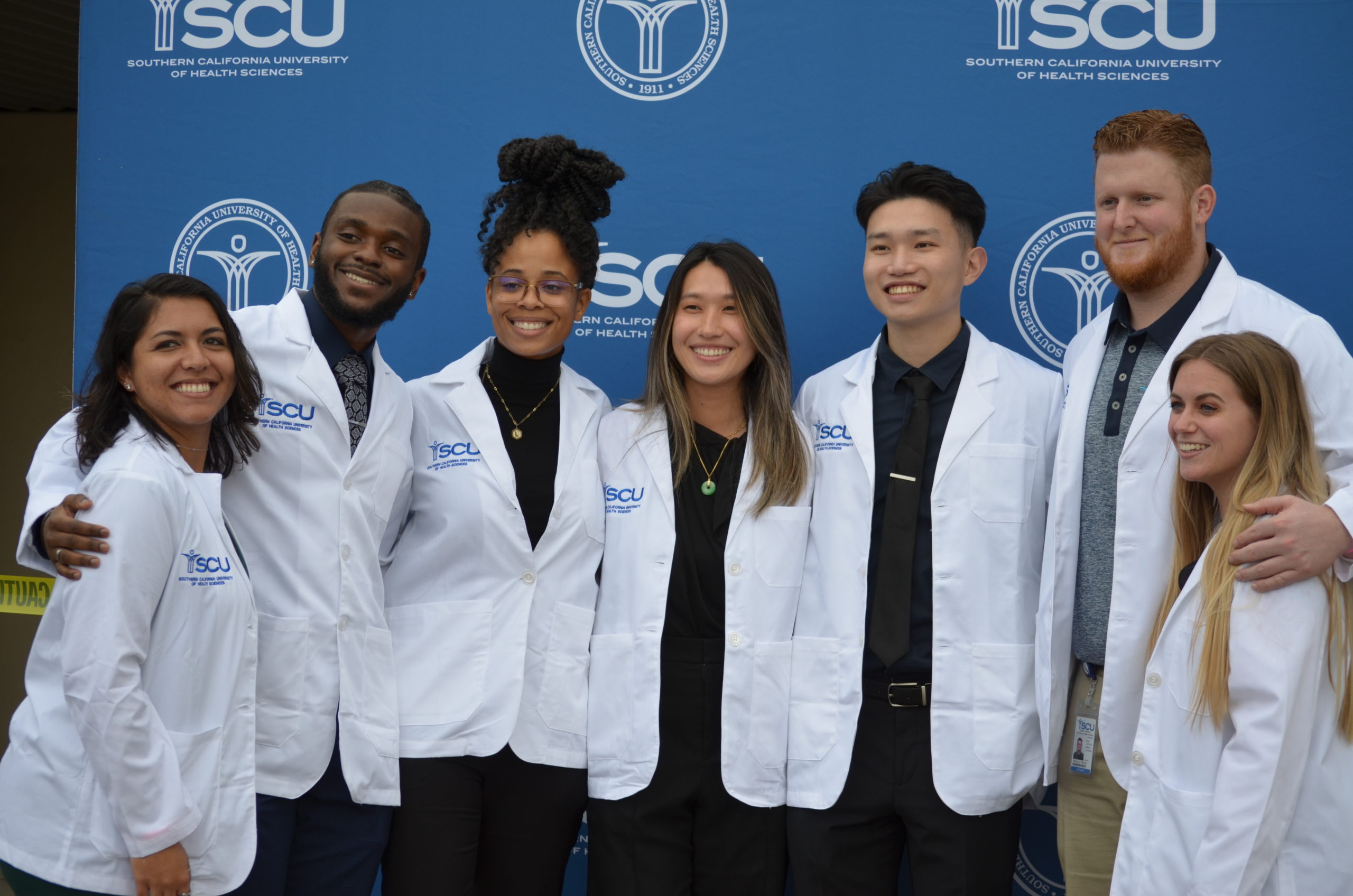 A group photo of SCU students after receiving their white coats