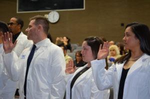 SCU DC students students reciting the Oath of Professionalism during the Spring 2023 White Coat Ceremony.
