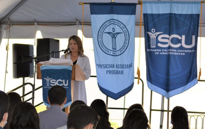 A photo of SCU MSPA Program Director Melanie Catalano, MSPA, PA-C speaking to students during a White Coat Ceremony.