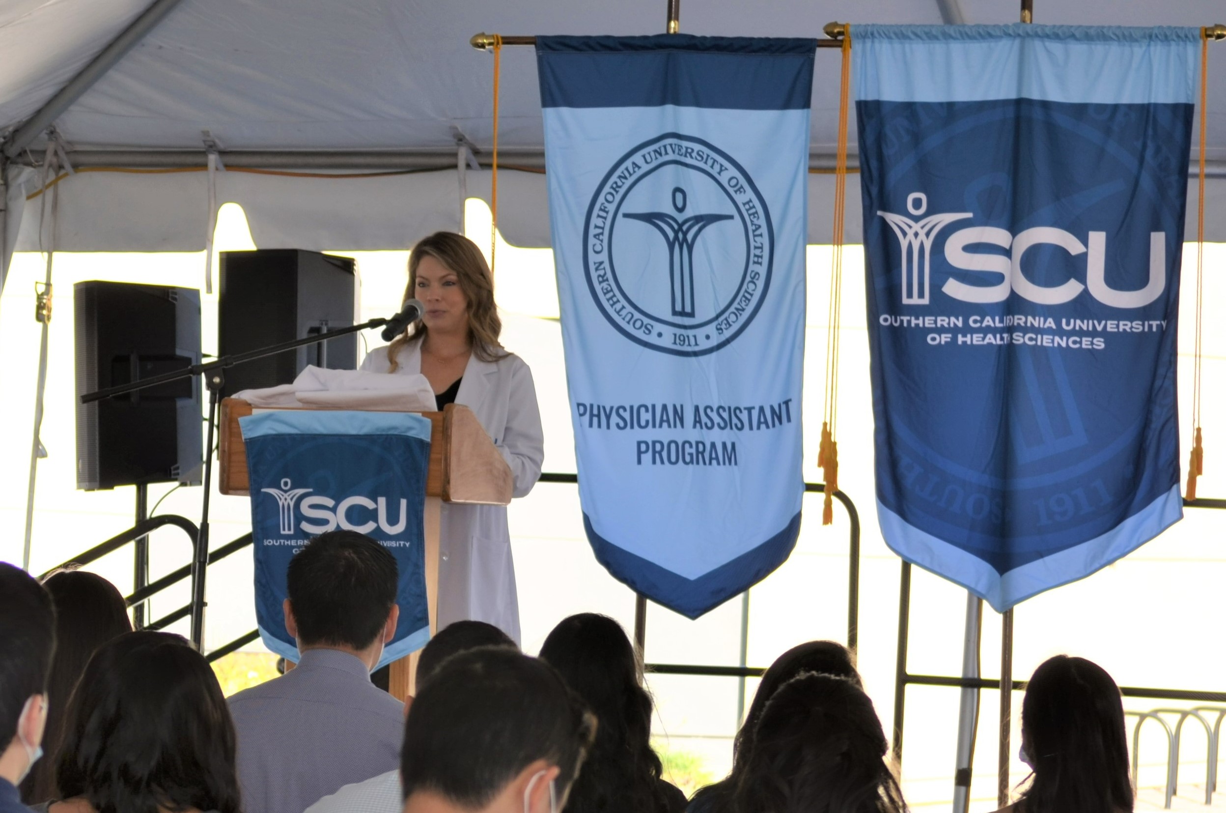 A photo of SCU MSPA Program Director Melanie Catalano, MSPA, PA-C speaking to students during a White Coat Ceremony.