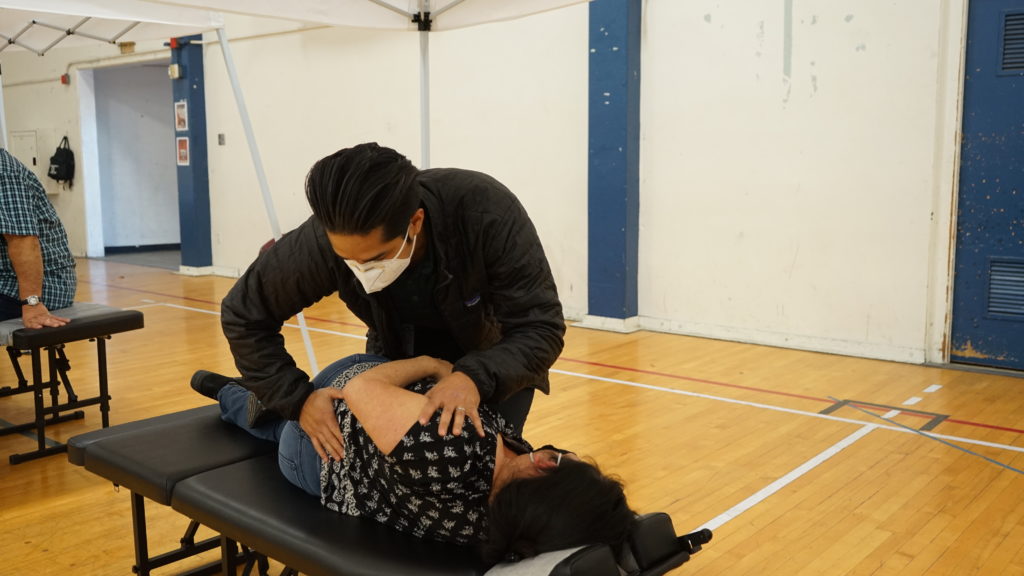 An action photo of a chiropractic adjustment being made on a patient