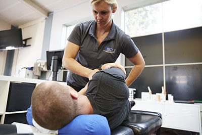 chiropractor adjusting patient